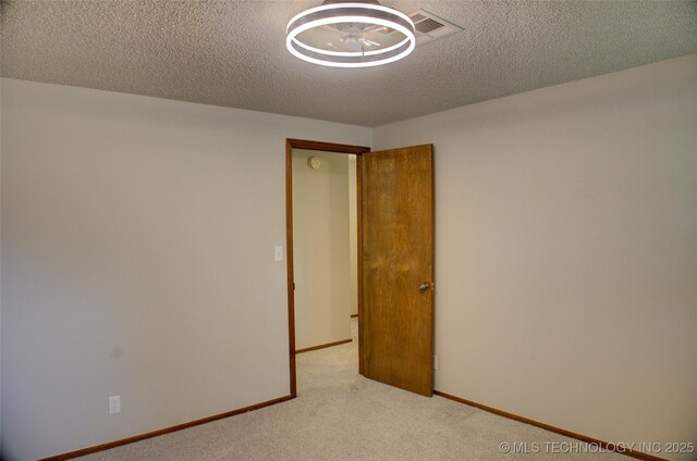 8242 S Sandusky Ave, Tulsa, OK 74137 - unfurnished room with carpet floors, a textured ceiling, and baseboards