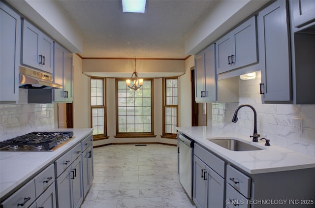 8242 S Sandusky Ave, Tulsa, OK 74137 - kitchen with a sink, appliances with stainless steel finishes, under cabinet range hood, light marble finish flooring, and a chandelier