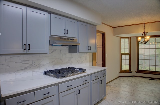 8242 S Sandusky Ave, Tulsa, OK 74137 - kitchen featuring under cabinet range hood, stainless steel gas stovetop, light marble finish floors, tasteful backsplash, and a textured ceiling