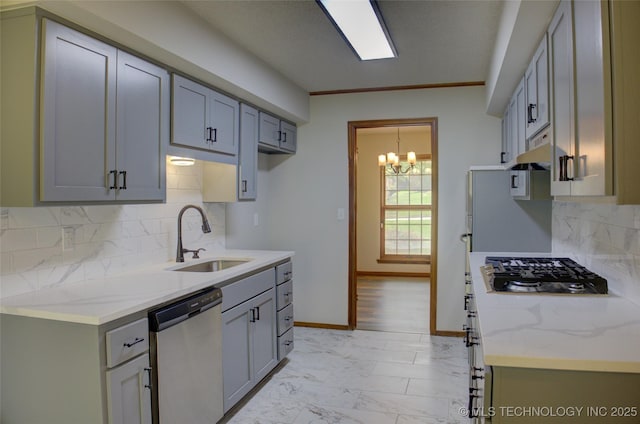 8242 S Sandusky Ave, Tulsa, OK 74137 - kitchen with stainless steel appliances, a sink, a chandelier, light marble finish flooring, and tasteful backsplash