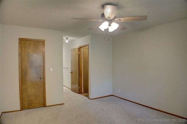 8242 S Sandusky Ave, Tulsa, OK 74137 - unfurnished bedroom featuring carpet floors, a ceiling fan, baseboards, and a textured ceiling