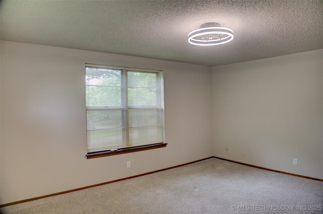 8242 S Sandusky Ave, Tulsa, OK 74137 - carpeted empty room featuring a textured ceiling and baseboards