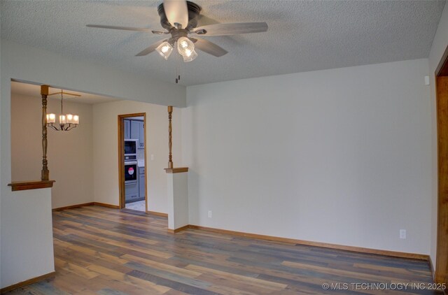 8242 S Sandusky Ave, Tulsa, OK 74137 - unfurnished room with a ceiling fan, wood finished floors, a textured ceiling, baseboards, and a chandelier