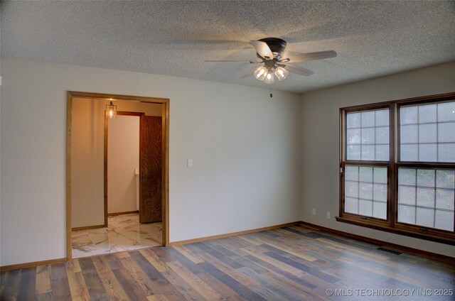 8242 S Sandusky Ave, Tulsa, OK 74137 - spare room featuring light wood-style flooring, a ceiling fan, a textured ceiling, and baseboards