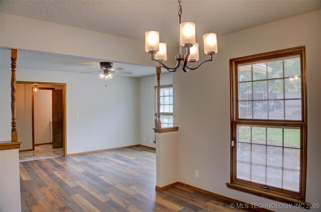 8242 S Sandusky Ave, Tulsa, OK 74137 - empty room with wood finished floors, a ceiling fan, baseboards, a chandelier, and a textured ceiling
