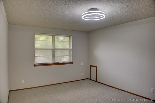8242 S Sandusky Ave, Tulsa, OK 74137 - carpeted spare room featuring a textured ceiling and baseboards
