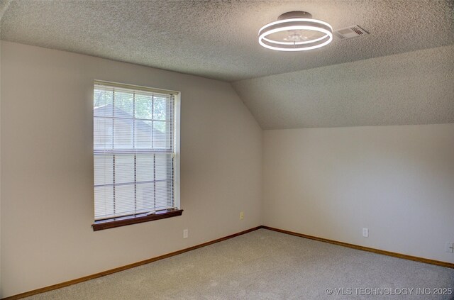 8242 S Sandusky Ave, Tulsa, OK 74137 - additional living space with a textured ceiling, carpet, lofted ceiling, and baseboards