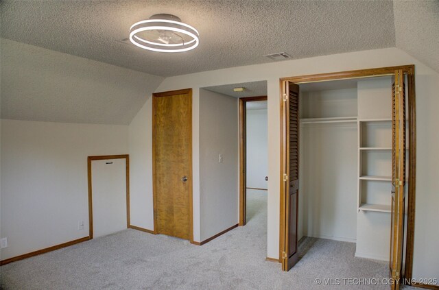 8242 S Sandusky Ave, Tulsa, OK 74137 - unfurnished bedroom featuring carpet flooring, a textured ceiling, vaulted ceiling, and baseboards