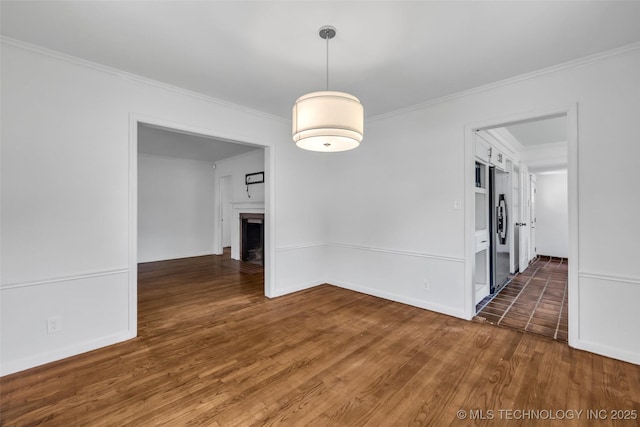 1223 E 31st St, Tulsa, OK 74105 - spare room featuring ornamental molding, wood finished floors, a fireplace, and baseboards