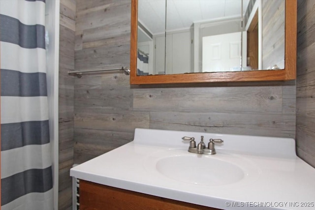 full bathroom with wooden walls, vanity, and a shower with curtain