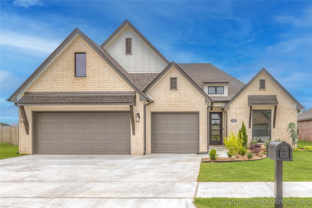 2989 E 145th St S, Bixby, OK 74008 - view of front of home with board and batten siding, driveway, brick siding, a shingled roof, and a front yard