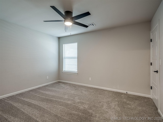 carpeted empty room with ceiling fan and baseboards