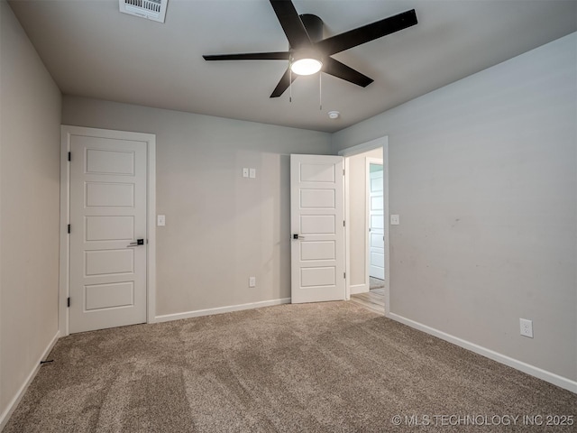 spare room with ceiling fan, carpet floors, and baseboards
