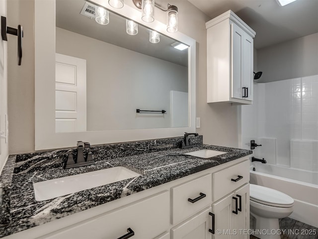 bathroom featuring double vanity, toilet, and washtub / shower combination