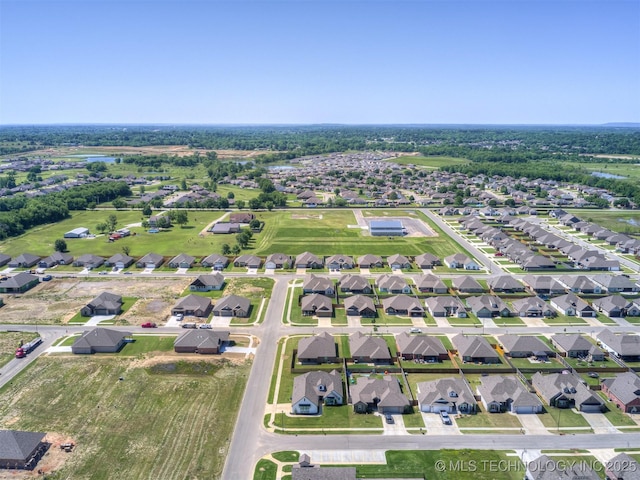 aerial view of property and surrounding area with nearby suburban area