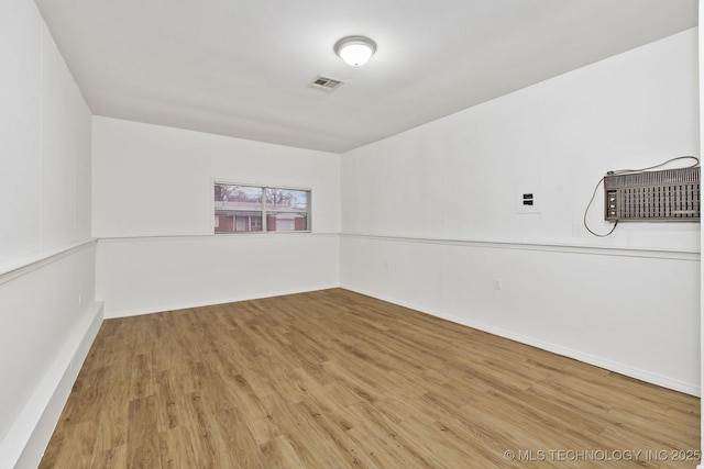 empty room with wood finished floors and baseboards