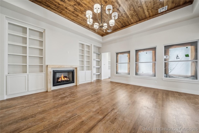 2607 E 135th Dr S, Bixby, OK 74008 - unfurnished living room with wood ceiling, built in shelves, a chandelier, wood finished floors, and a fireplace