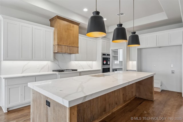 2607 E 135th Dr S, Bixby, OK 74008 - kitchen with gas stovetop, dark wood-type flooring, white cabinetry, an island with sink, and recessed lighting