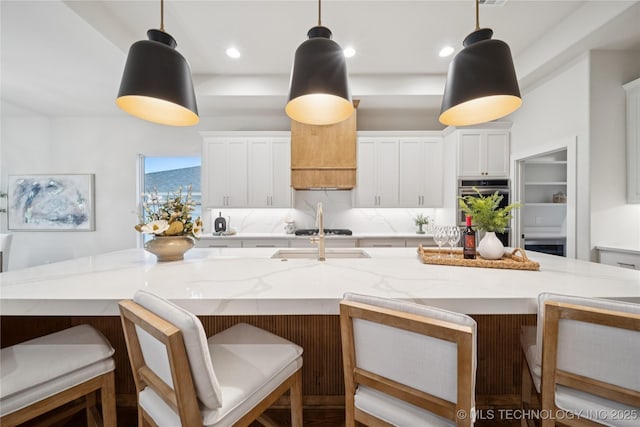 2607 E 135th Dr S, Bixby, OK 74008 - kitchen with stainless steel double oven, white cabinets, gas cooktop, and pendant lighting