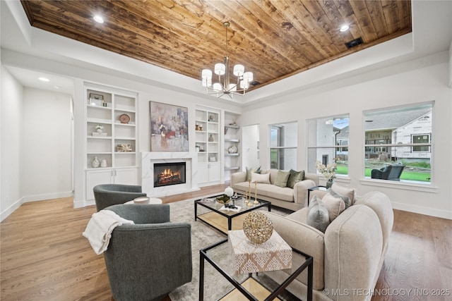 2607 E 135th Dr S, Bixby, OK 74008 - living area featuring wood ceiling, a high end fireplace, recessed lighting, a raised ceiling, and a chandelier