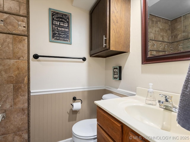 540 S Hamilton Ave, Dewey, OK 74029 - bathroom with a wainscoted wall, toilet, and vanity