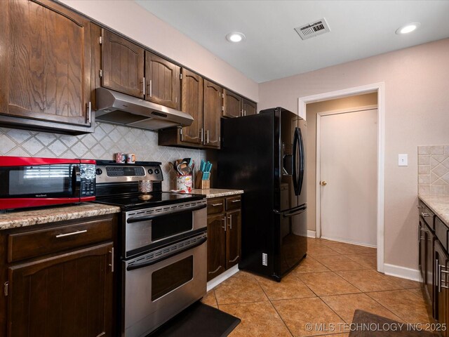 540 S Hamilton Ave, Dewey, OK 74029 - kitchen with range with two ovens, under cabinet range hood, black refrigerator with ice dispenser, tasteful backsplash, and dark brown cabinets