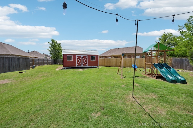 12 E 157th St S, Glenpool, OK 74033 - view of yard with a shed, a playground, and an outbuilding