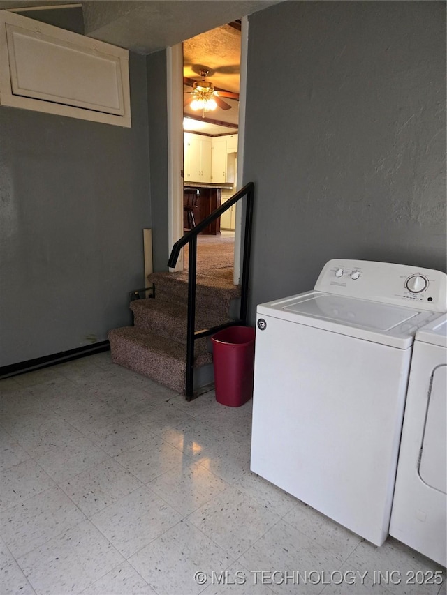 washroom featuring washing machine and dryer and a ceiling fan