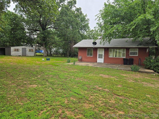 view of grassy yard featuring a patio area, a storage shed, and an outdoor structure