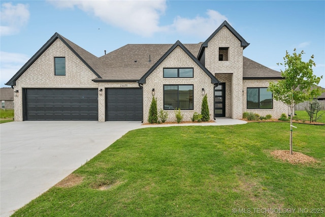 23079 E 106th Pl S, Broken Arrow, OK 74014 - view of front of home with roof with shingles, concrete driveway, a front lawn, and brick siding