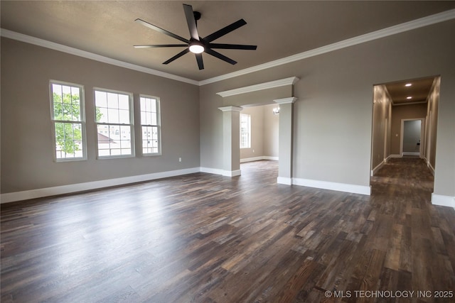 100 E Broadway, Sulphur, OK 73086 - spare room featuring ceiling fan, dark wood-type flooring, crown molding, baseboards, and decorative columns