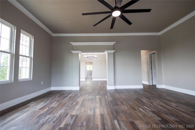 100 E Broadway, Sulphur, OK 73086 - empty room featuring healthy amount of natural light, dark wood-style flooring, ceiling fan, a chandelier, and crown molding