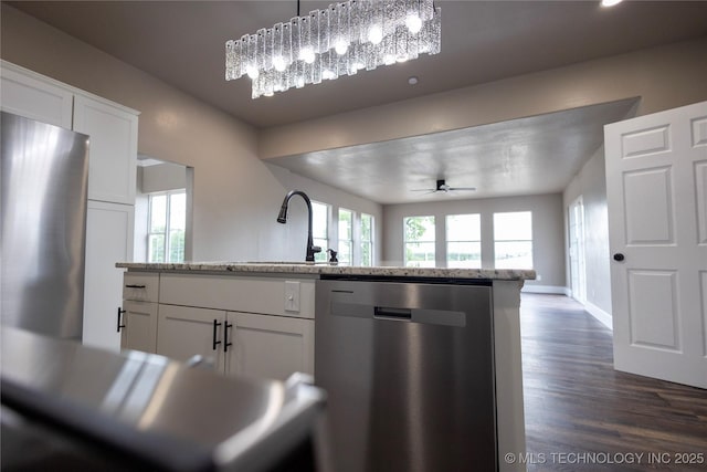100 E Broadway, Sulphur, OK 73086 - kitchen featuring stainless steel appliances, a ceiling fan, a sink, dark wood finished floors, and white cabinets