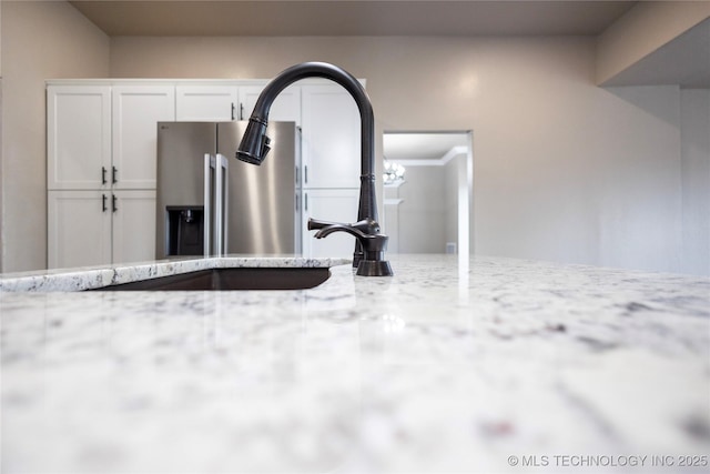 100 E Broadway, Sulphur, OK 73086 - kitchen view of white cabinets, light stone countertops, and a sink