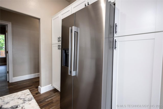 100 E Broadway, Sulphur, OK 73086 - kitchen with stainless steel fridge, baseboards, dark wood finished floors, and white cabinets