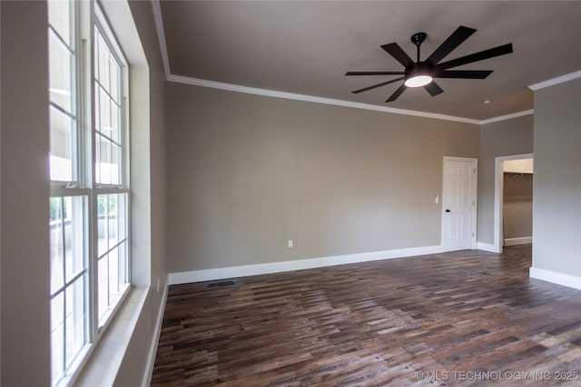 100 E Broadway, Sulphur, OK 73086 - spare room with dark wood-type flooring, ornamental molding, baseboards, and ceiling fan