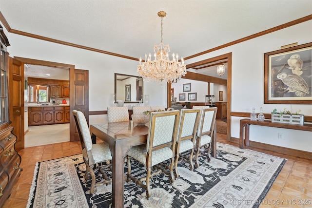 2956 E 69th St, Tulsa, OK 74136 - dining room featuring a chandelier, crown molding, a textured ceiling, and baseboards