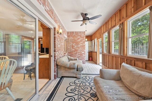 2956 E 69th St, Tulsa, OK 74136 - sunroom with ceiling fan, wood walls, and brick wall