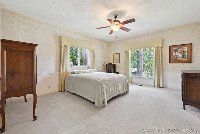 2956 E 69th St, Tulsa, OK 74136 - bedroom with wallpapered walls, multiple windows, a textured ceiling, light colored carpet, and ornamental molding