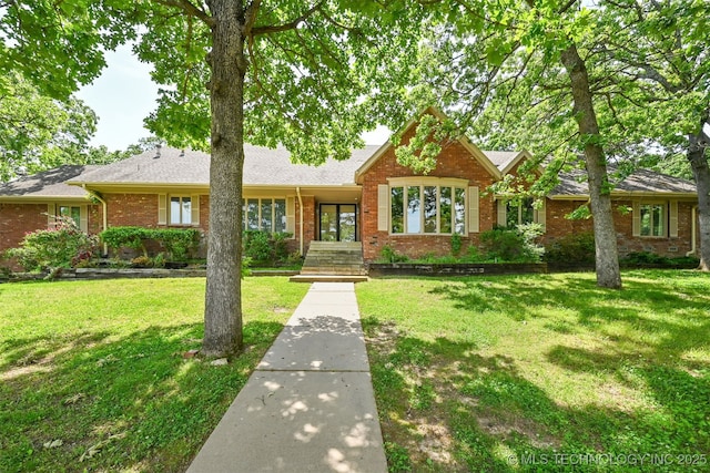 2956 E 69th St, Tulsa, OK 74136 - view of front of house with brick siding and a front yard