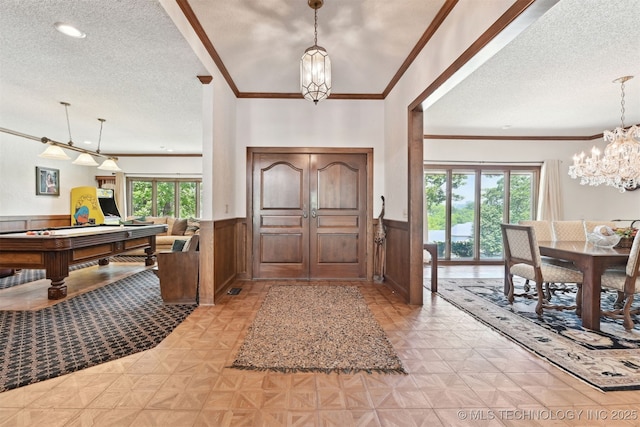 2956 E 69th St, Tulsa, OK 74136 - foyer with a textured ceiling, a chandelier, wainscoting, crown molding, and billiards