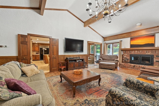 2956 E 69th St, Tulsa, OK 74136 - living room featuring a wainscoted wall, high vaulted ceiling, a chandelier, wood walls, and a brick fireplace