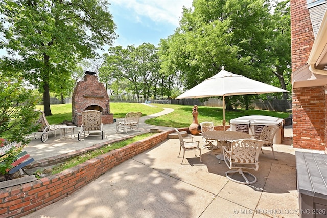2956 E 69th St, Tulsa, OK 74136 - view of patio with an outdoor brick fireplace and a jacuzzi