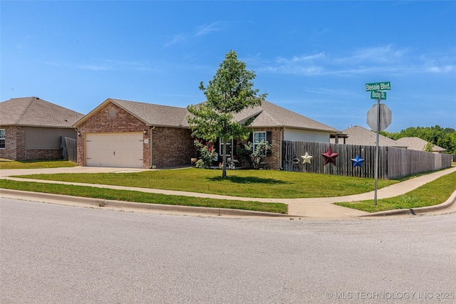 23218 Bessie Blvd, Claremore, OK 74019 - ranch-style house featuring brick siding, an attached garage, and driveway