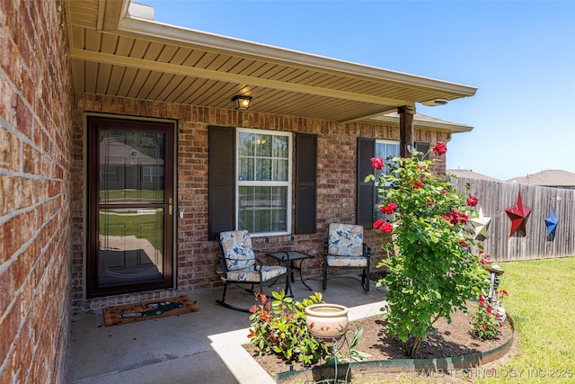 23218 Bessie Blvd, Claremore, OK 74019 - property entrance with covered porch, fence, and brick siding