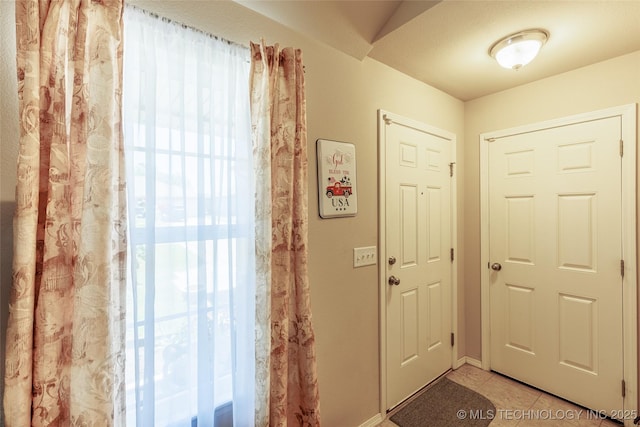23218 Bessie Blvd, Claremore, OK 74019 - entryway featuring plenty of natural light, light tile patterned floors, and baseboards