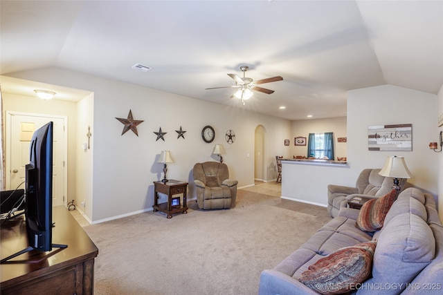 23218 Bessie Blvd, Claremore, OK 74019 - carpeted living area featuring arched walkways, vaulted ceiling, ceiling fan, and baseboards