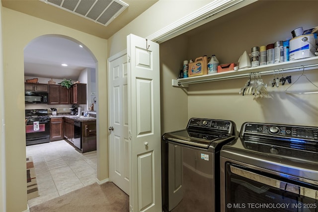 23218 Bessie Blvd, Claremore, OK 74019 - laundry area with arched walkways, separate washer and dryer, and light carpet