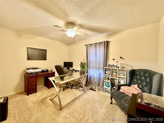 home office featuring ceiling fan, carpet, and a textured ceiling