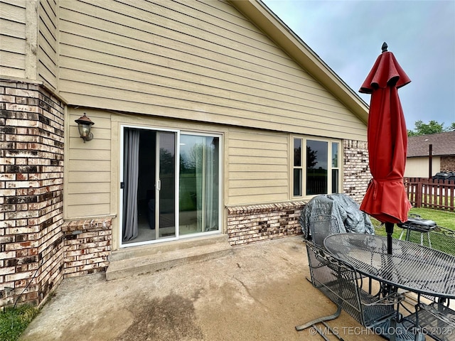 view of patio featuring fence and outdoor dining area